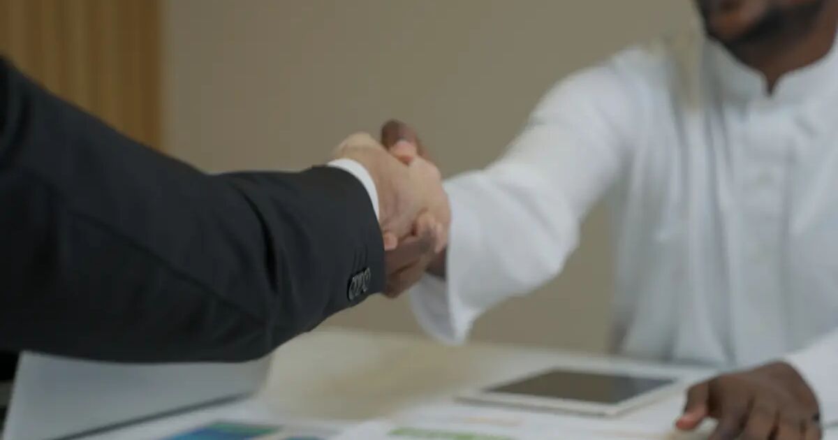 Security company and client shaking hands over a contract
