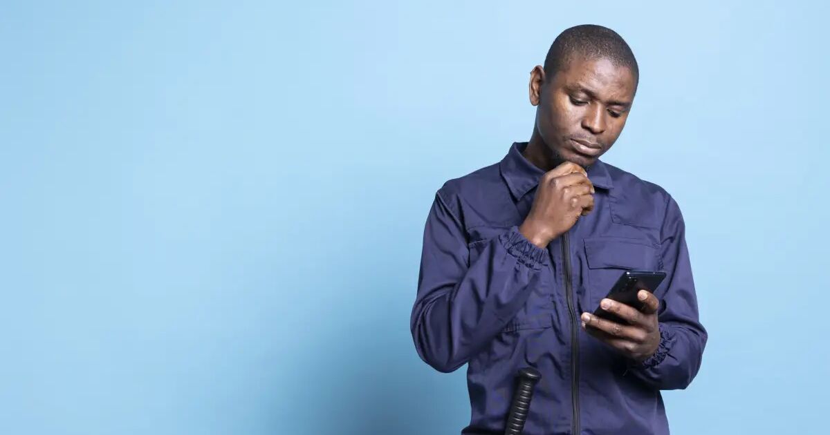 Security guard checking a shift roster on a mobile phone